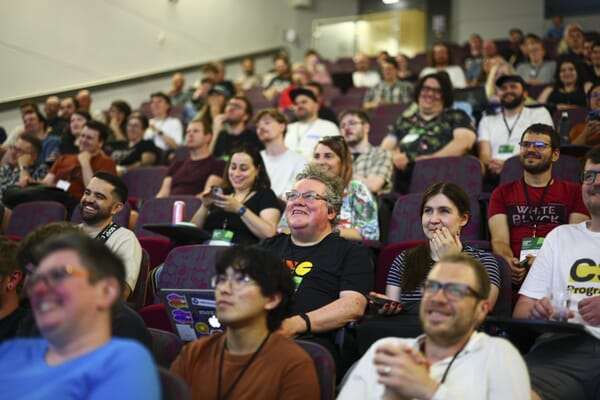 Smiling audience members mid-talk